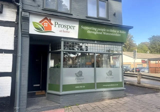 The Prosper at Home office on Queen Street, Droitwich Spa, with a green and white sign reading Supporting people to thrive at home throughout Worcestershire